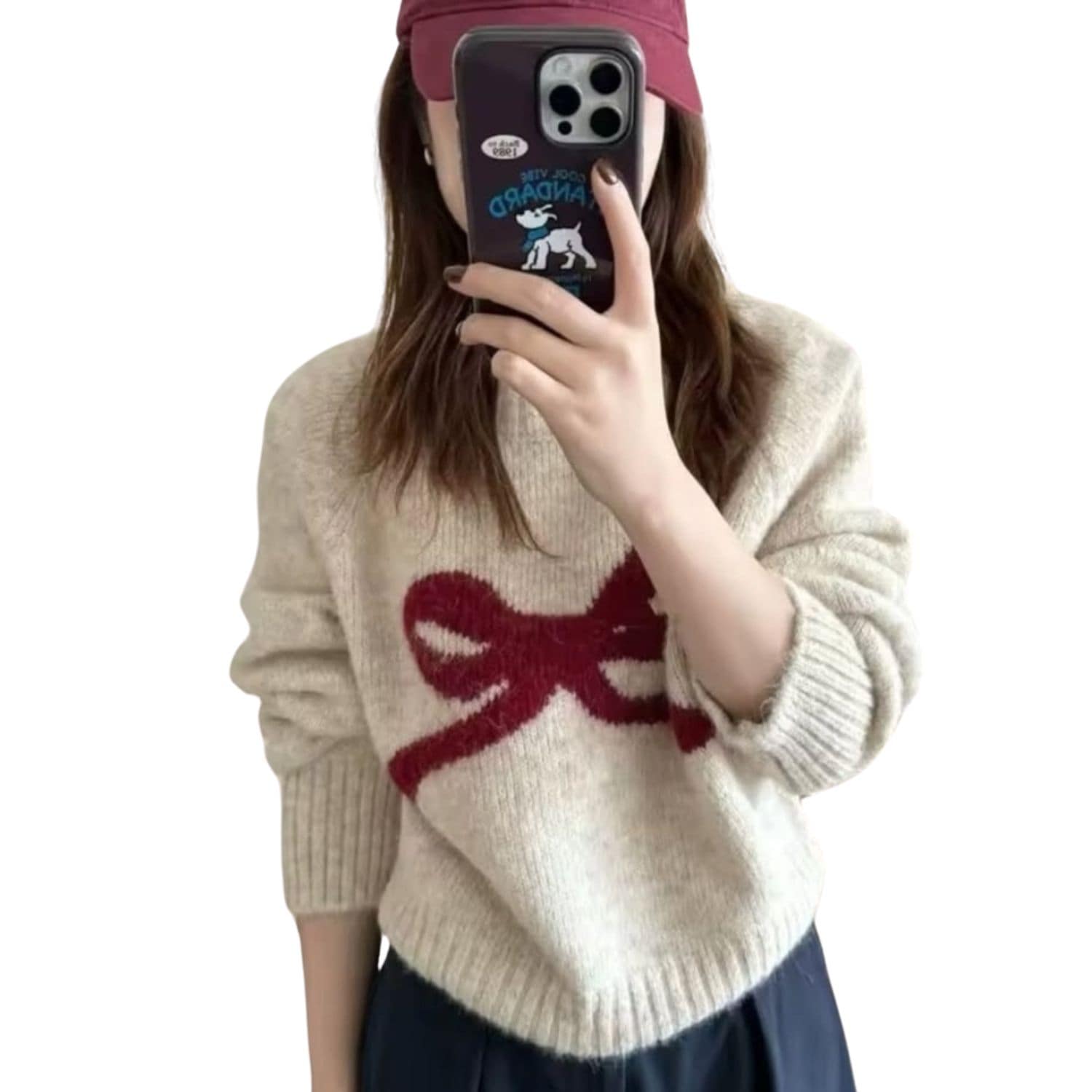 Woman wearing a beige knit sweater with a large red bow design on the front