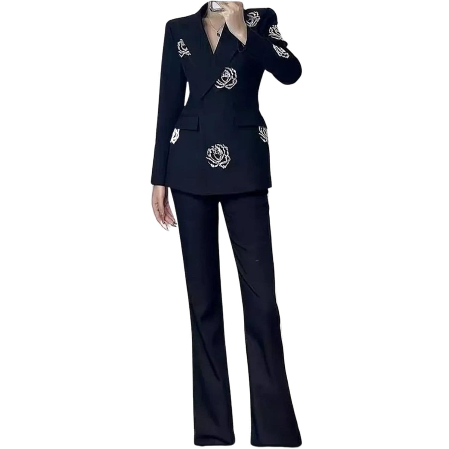 Woman wearing a black blazer and pants set decorated with crystal rose embellishments