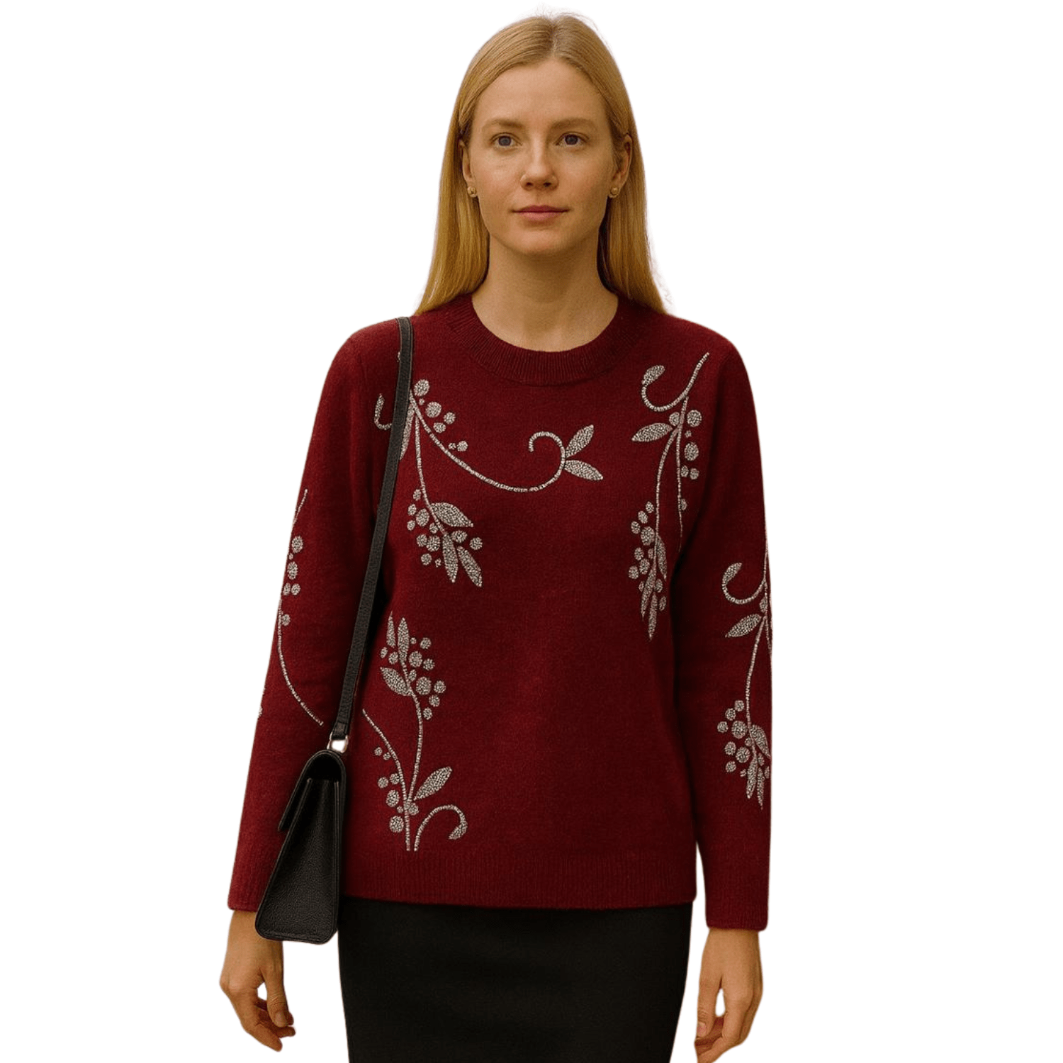 Woman wearing a burgundy knit sweater with silver vine embroidery, paired with black pants