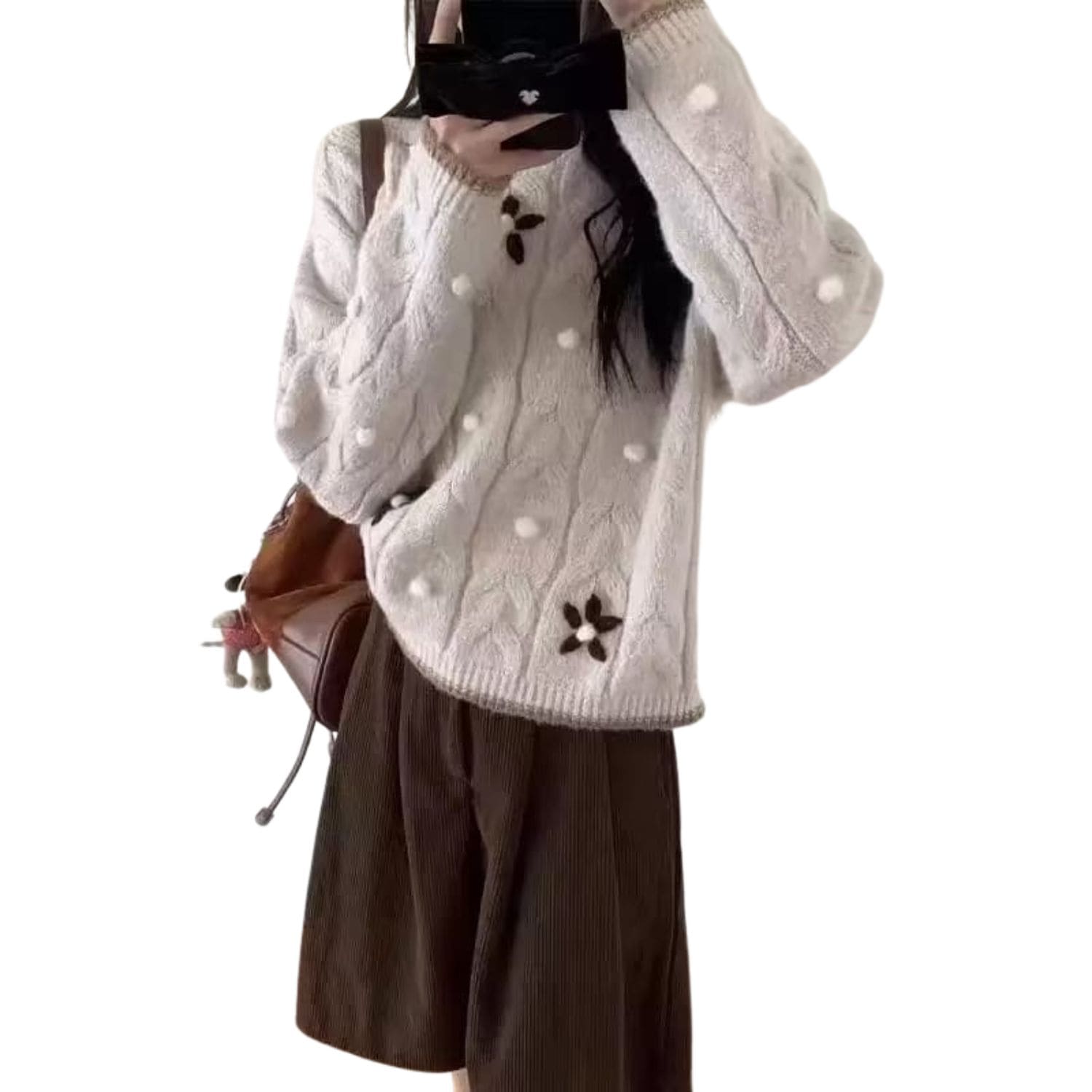 Cream cable-knit sweater with 3D pom-pom and brown flower detailing, cozy winter women’s knitwear.