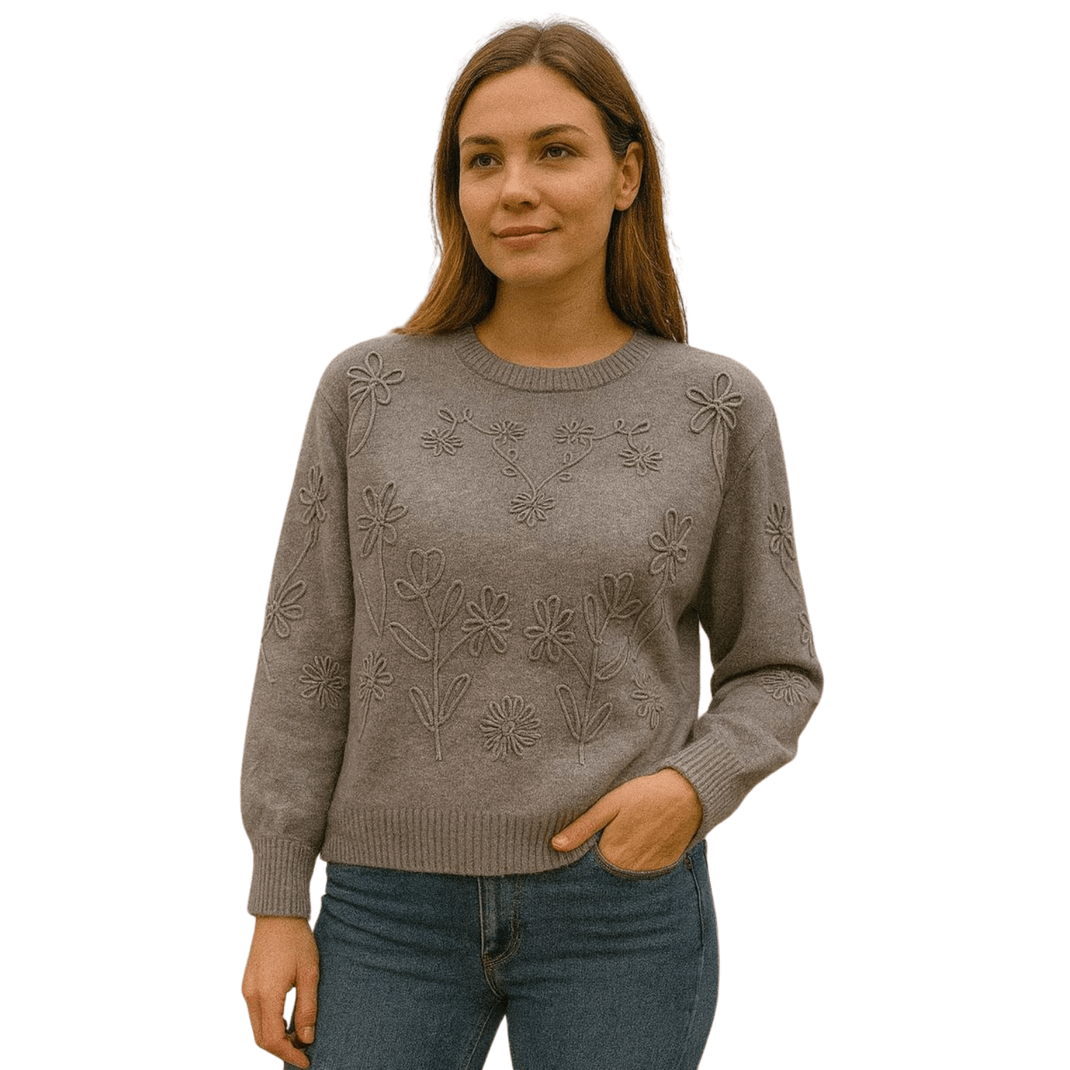 Woman wearing a gray knit sweater with raised floral embroidery detail, paired with blue jeans