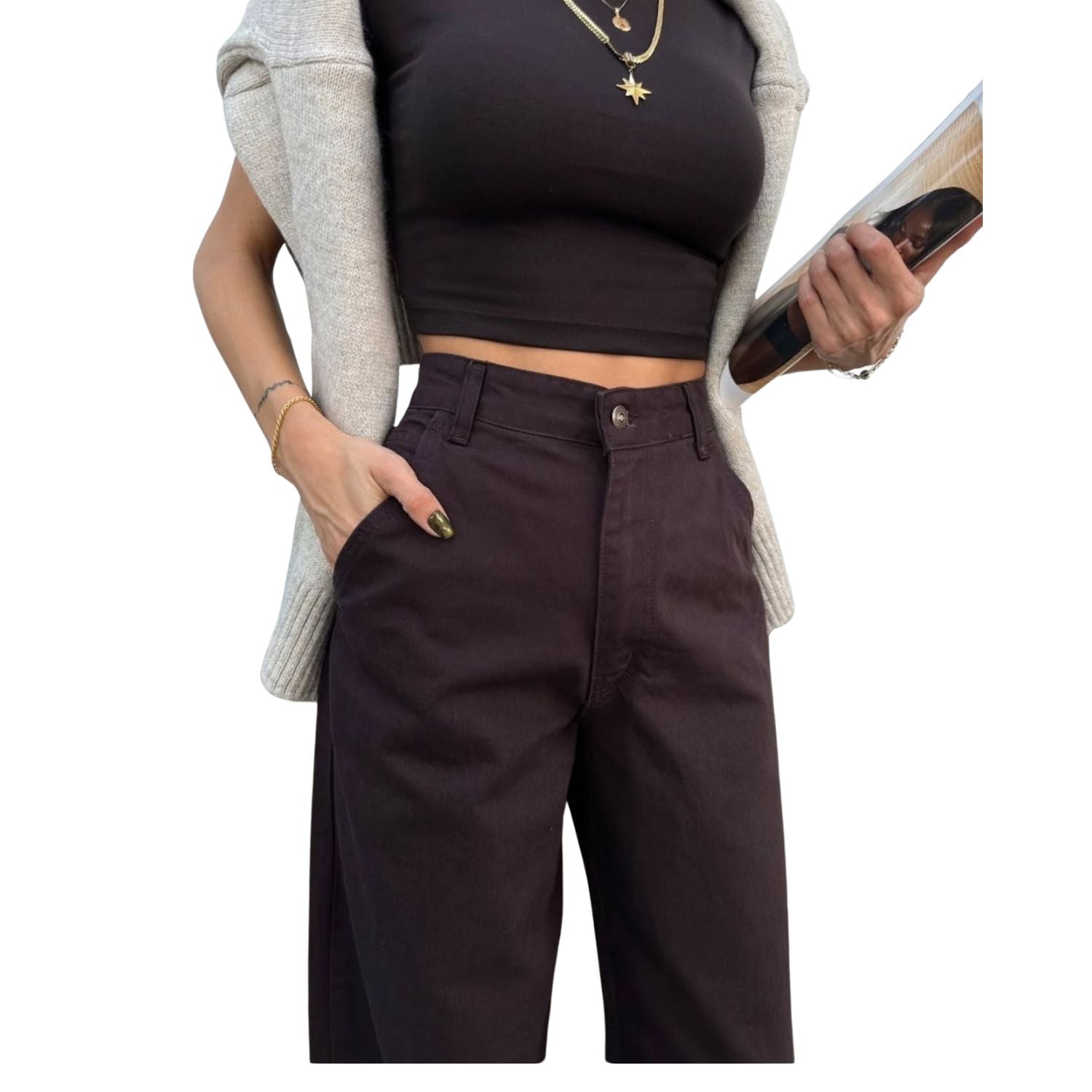 Close-up view of woman wearing high-waisted coffee brown wide leg pants with a black crop top