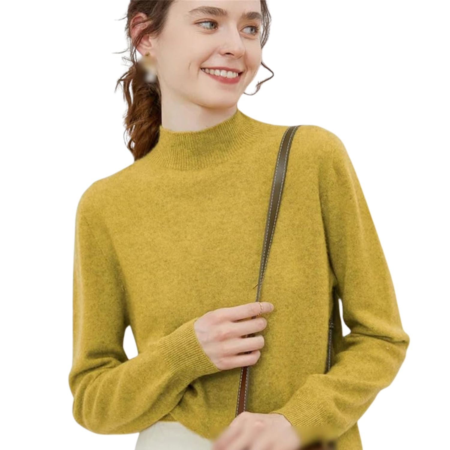 Woman wearing a mustard yellow mock-neck long-sleeve cashmere knit sweater while holding a brown shoulder bag