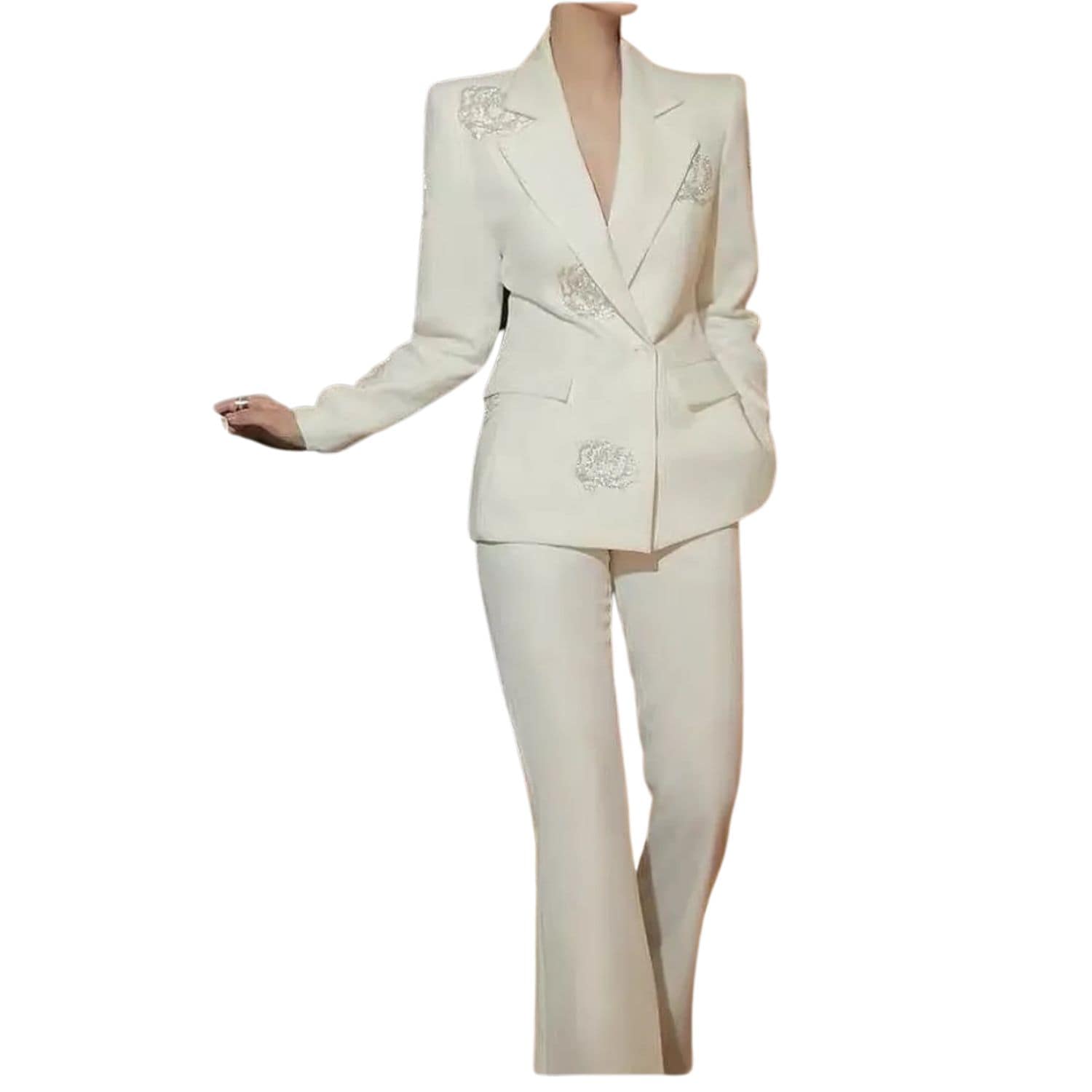 Woman wearing a white blazer and pants set decorated with crystal rose embellishments