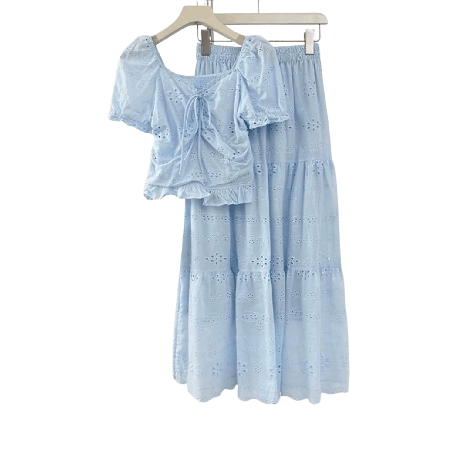 Women's blue eyelet lace two piece set featuring puff sleeve tie front top and matching tiered midi skirt on hanger