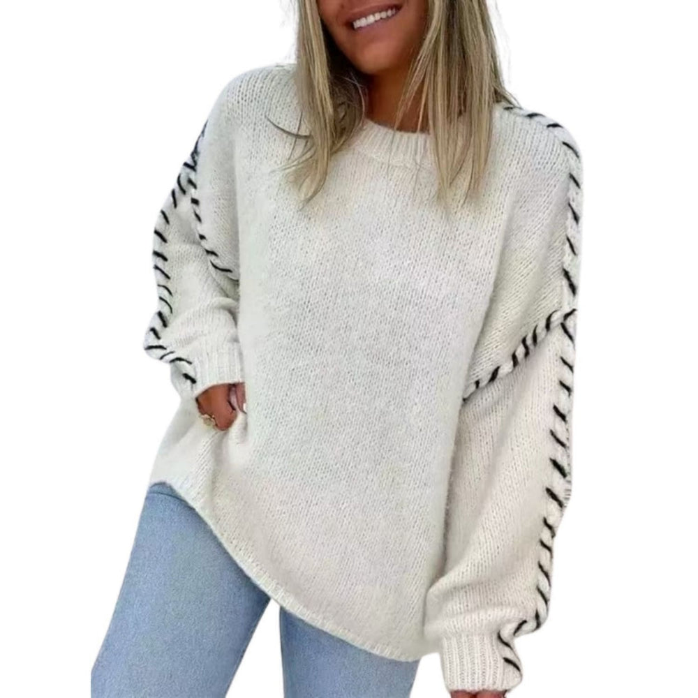 White/cream sweater:
“Woman wearing a white knit sweater with black braided sleeve detail and relaxed fit.”