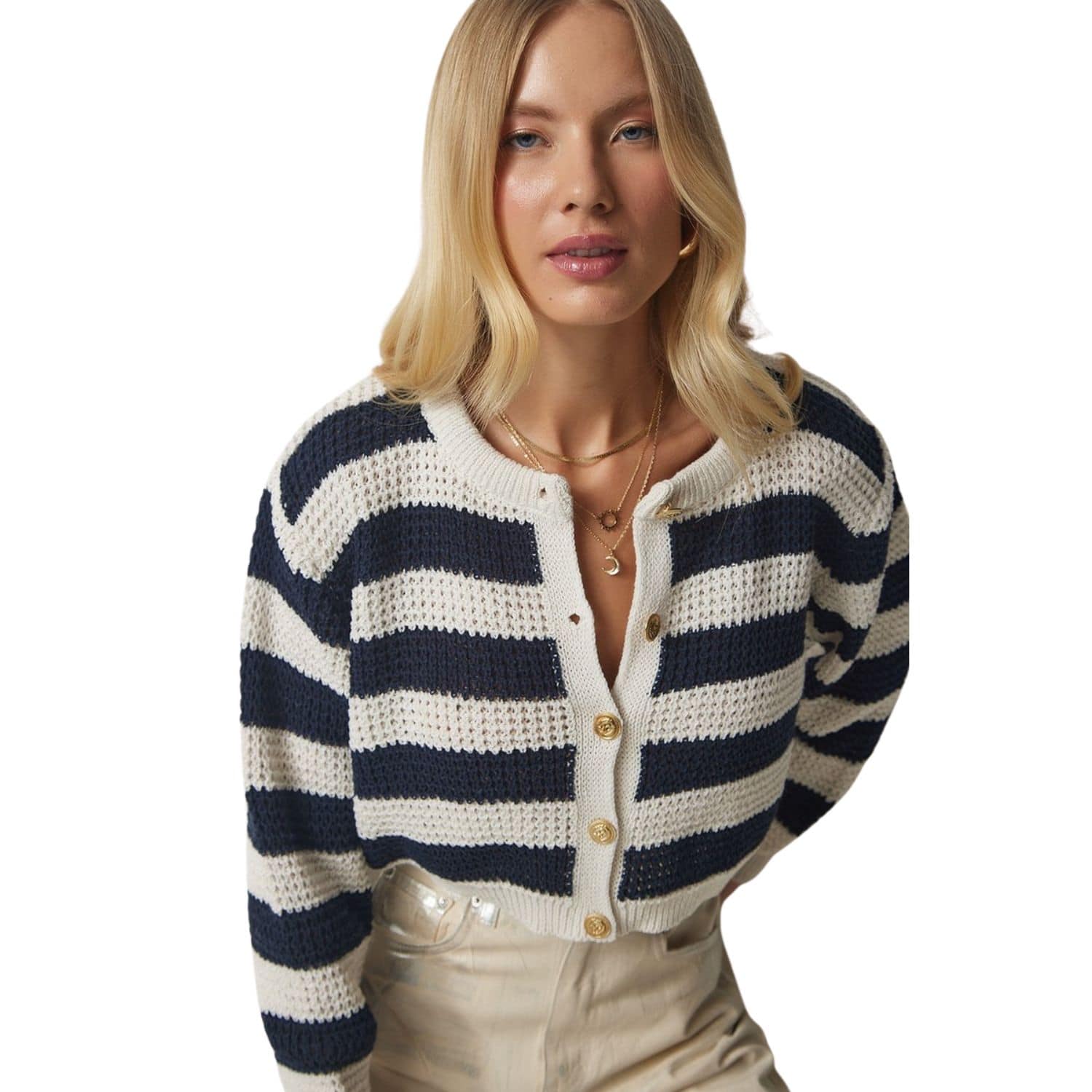 Woman wearing a navy and white striped cropped knit cardigan with gold buttons.