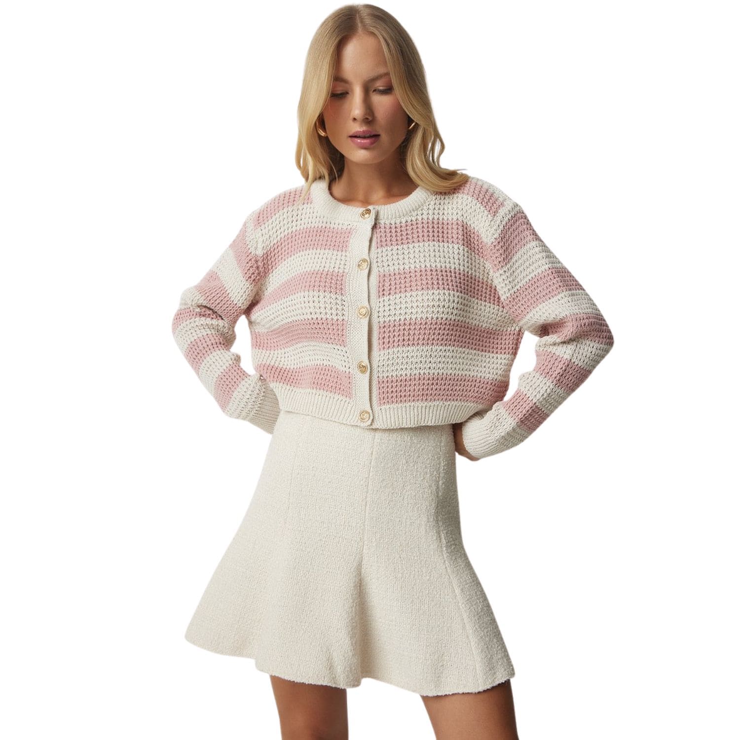 Woman wearing a pink and white striped cropped knit cardigan with gold buttons
