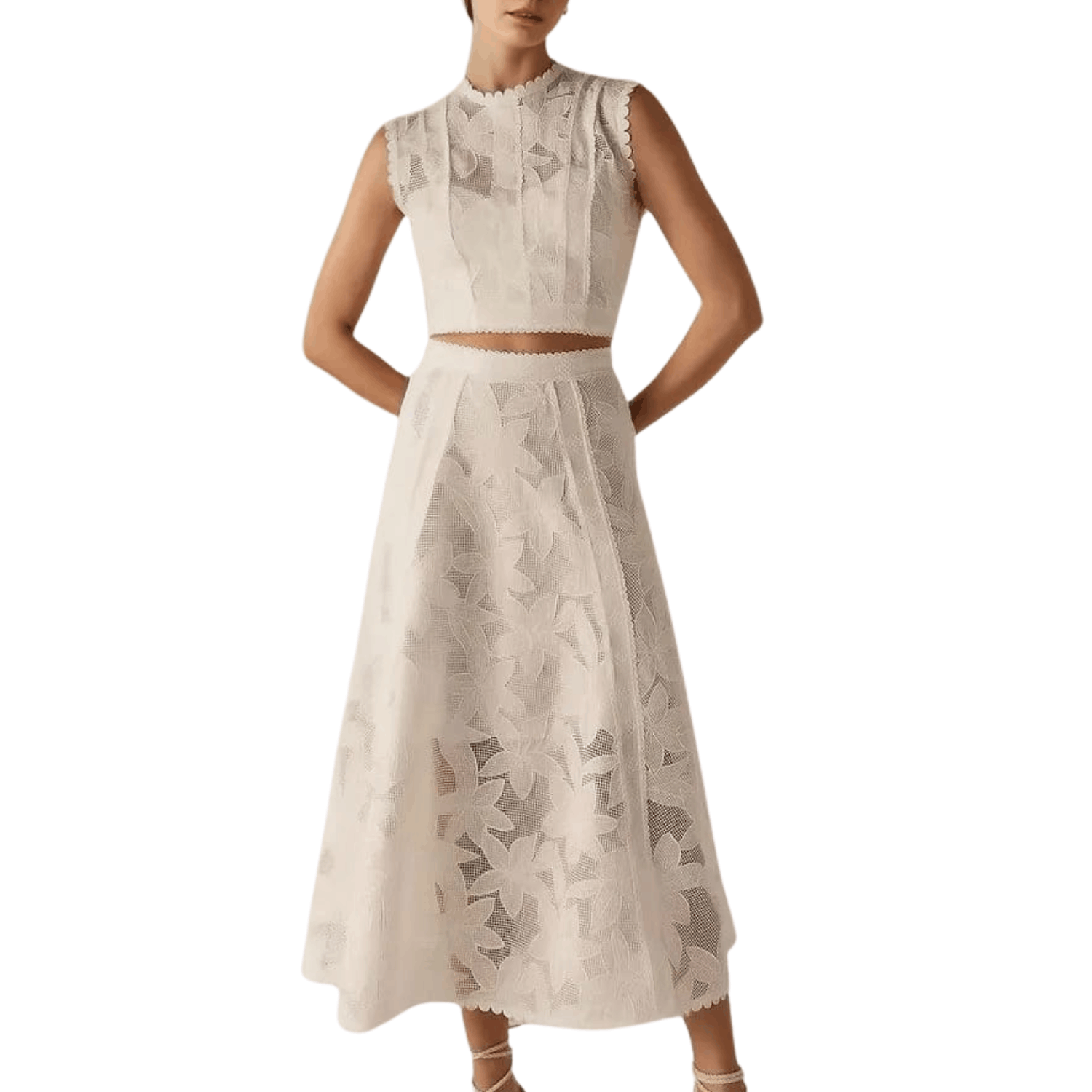Woman wearing a white floral lace two piece set with sleeveless crop top and midi skirt