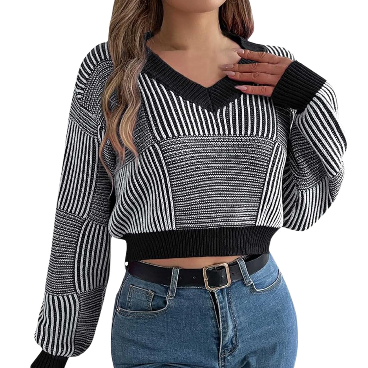 Cropped women’s knit sweater in black and white stripes, featuring a V-neckline and long sleeves, paired with blue jeans.
