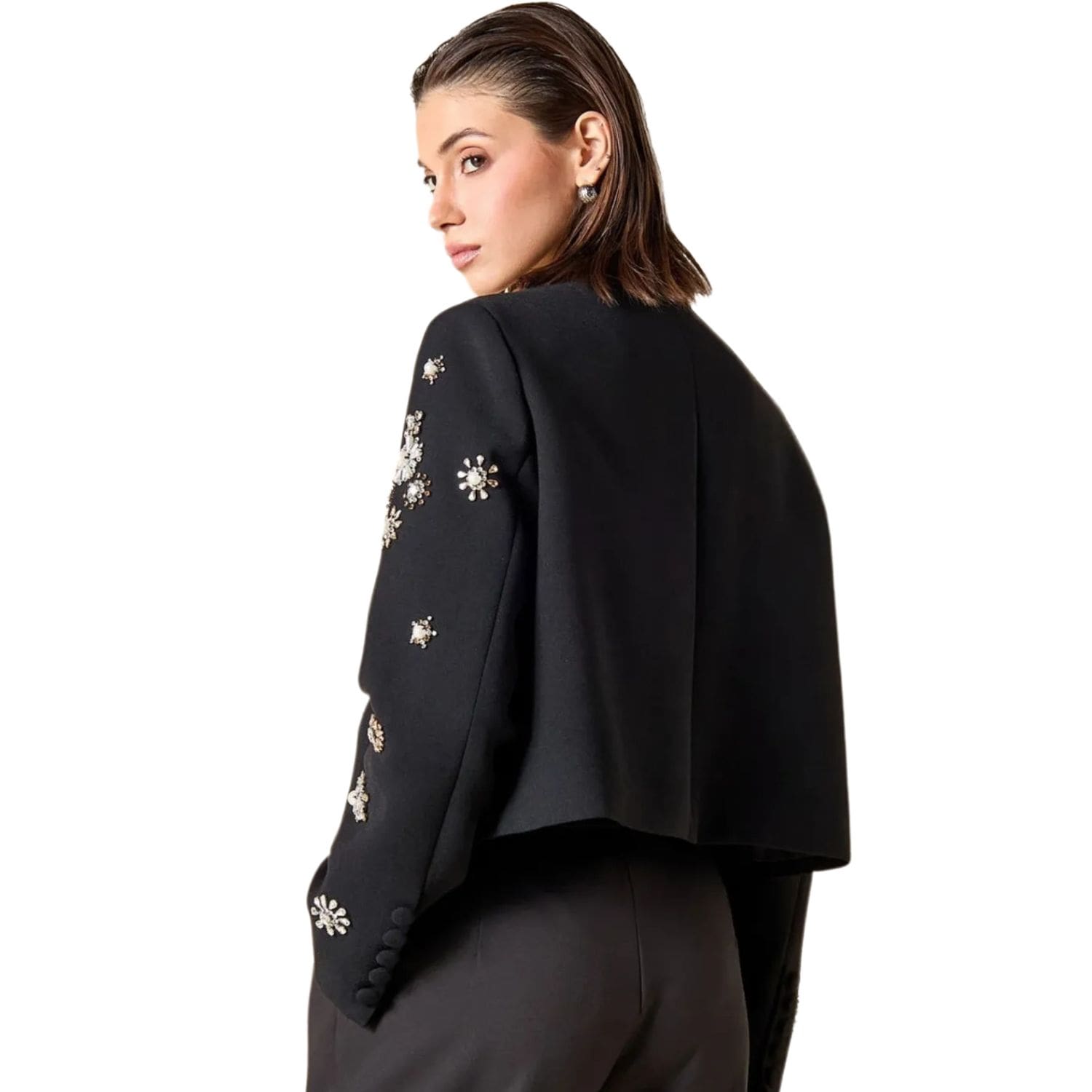Back view of black cropped jacket with crystal and floral embellishments on the sleeves.