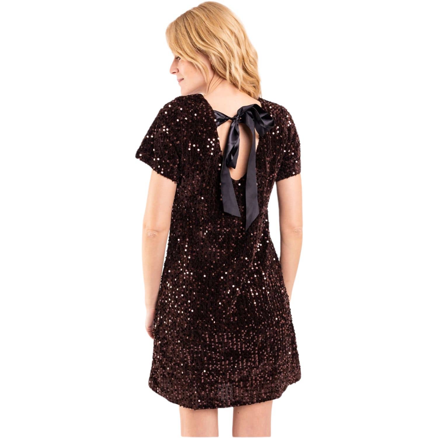 Back view of women’s brown sequin mini dress featuring an open back with a black bow detail