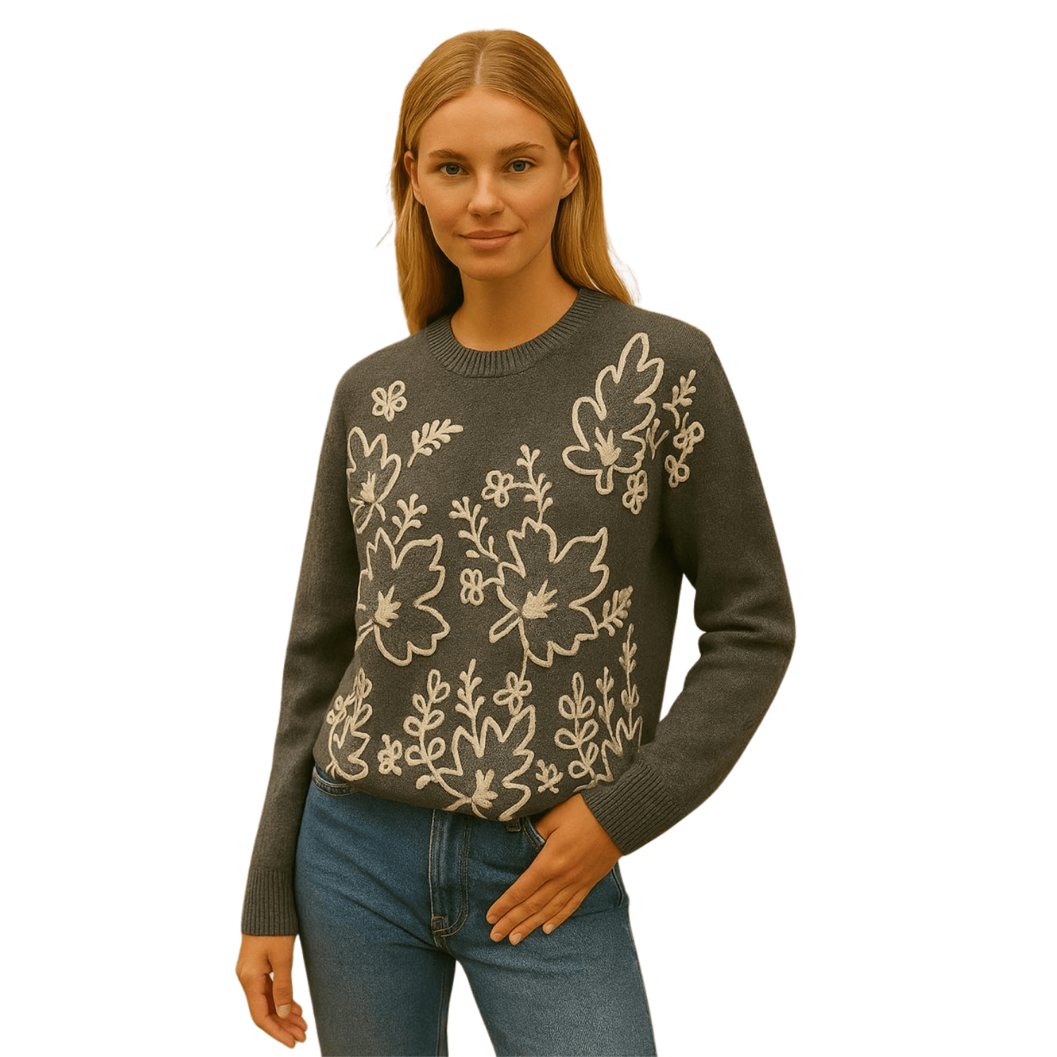 Woman wearing a charcoal gray knit sweater with cream floral embroidery, paired with blue jeans