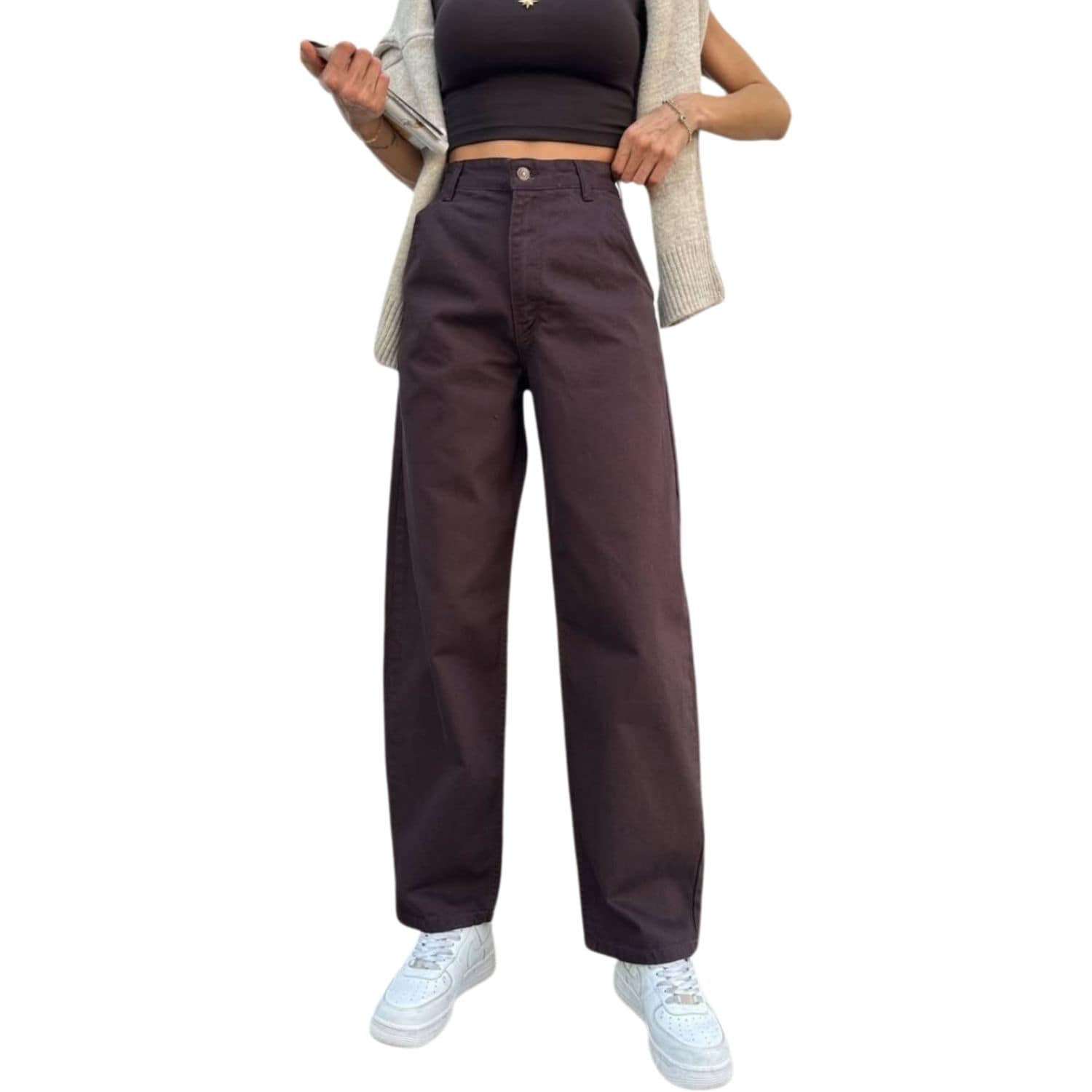 Woman wearing high-waisted wide leg coffee brown pants styled with sneakers