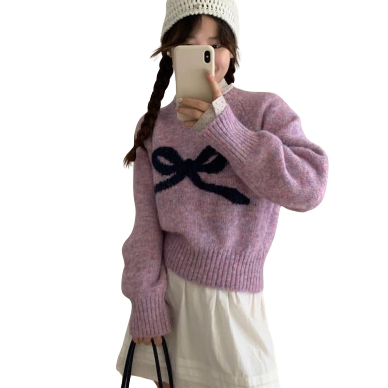 Woman wearing a pink knit sweater with a black bow design on the front