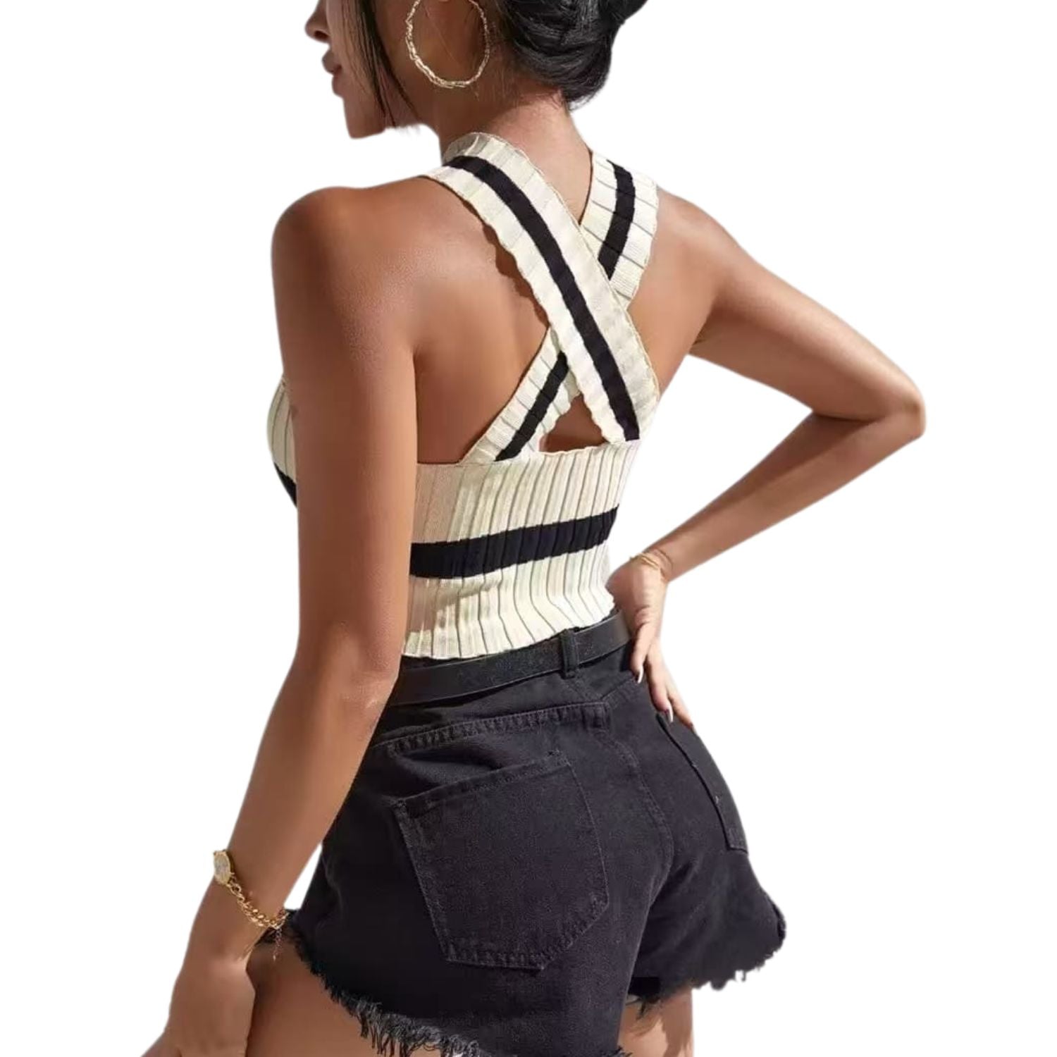 “Woman wearing a ribbed halter knit crop top with cross-back straps and black shorts.”