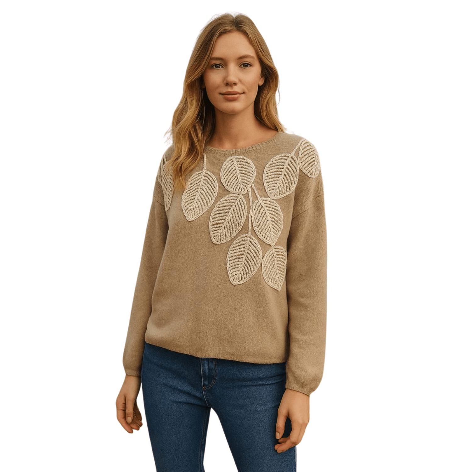 Woman wearing a taupe knit sweater with embroidered leaf design on the front, paired with blue jeans