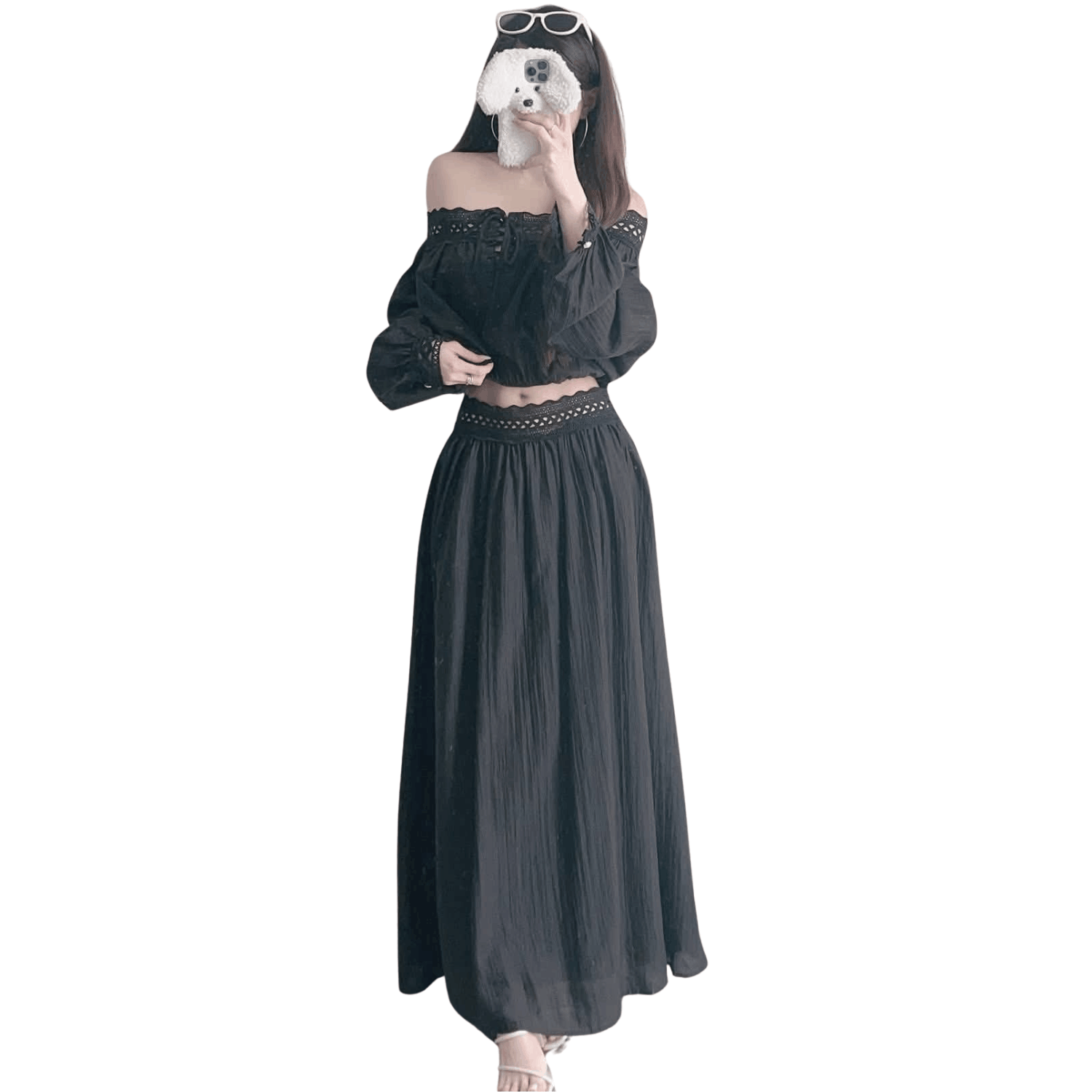 Woman wearing a black off shoulder two piece set with long sleeve crop top and flowy maxi skirt
