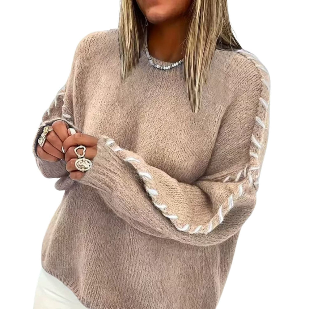 “Woman wearing a beige cozy knit sweater with braided sleeve detail and long sleeves.”