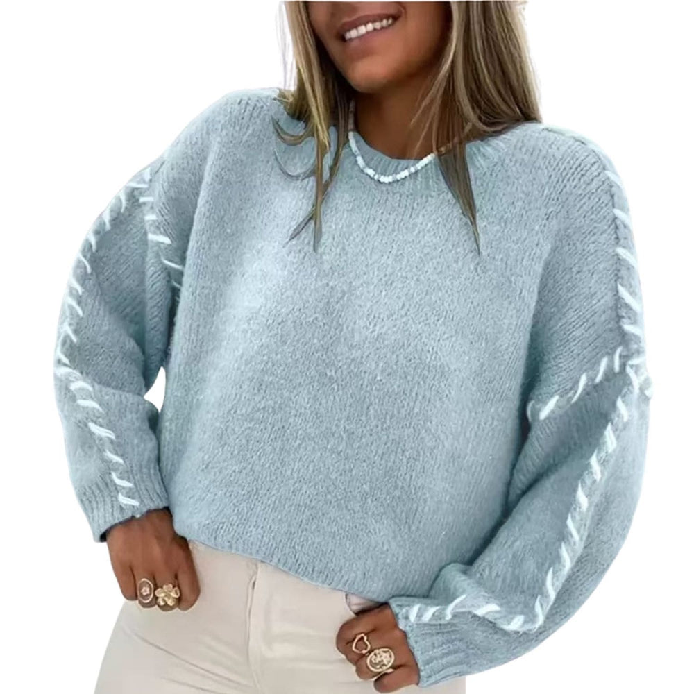 Woman wearing a light blue cozy knit sweater with braided sleeve detail and long sleeves.”

Steel blue sweater: