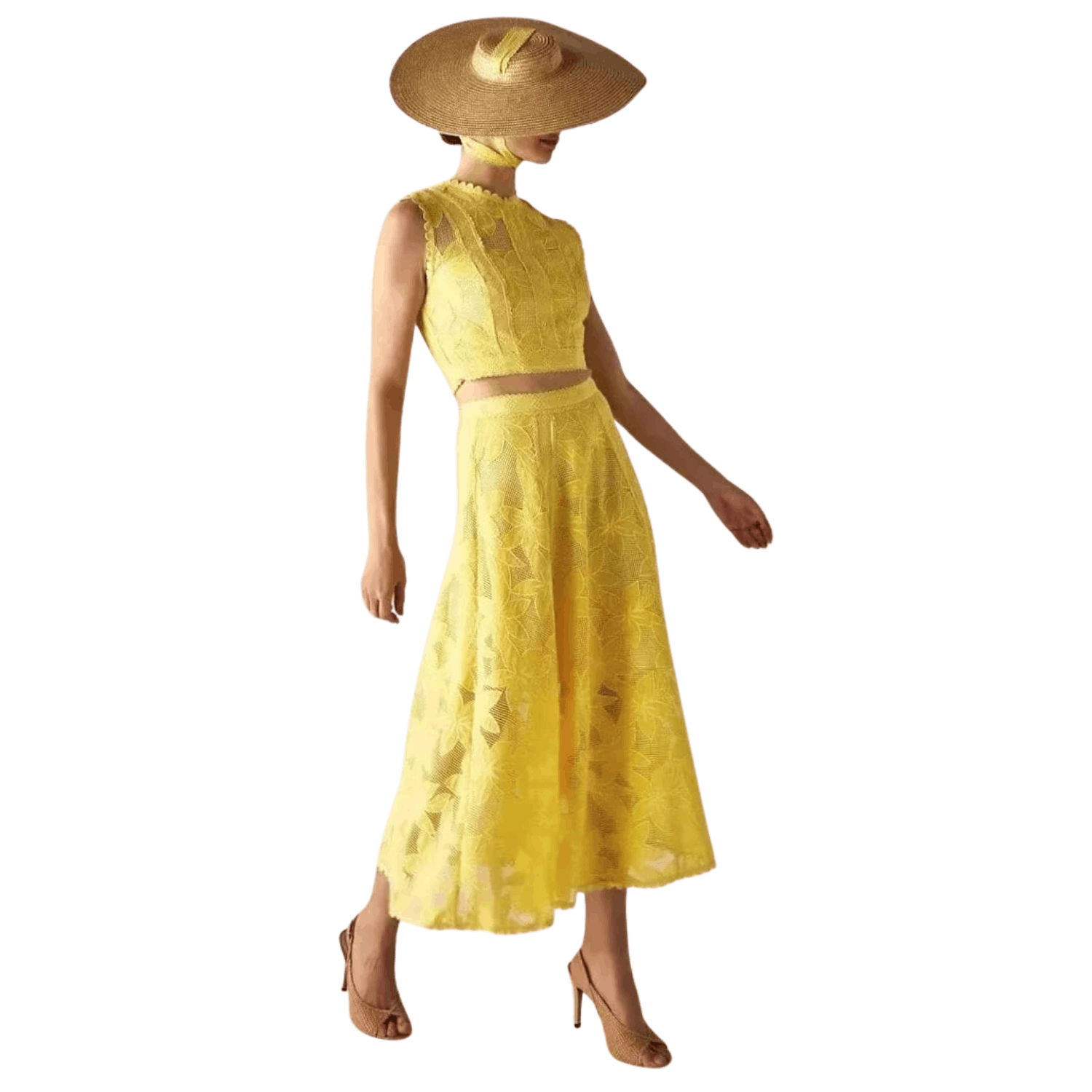 Woman wearing a yellow floral lace two piece set with sleeveless crop top and midi skirt and wide brim hat