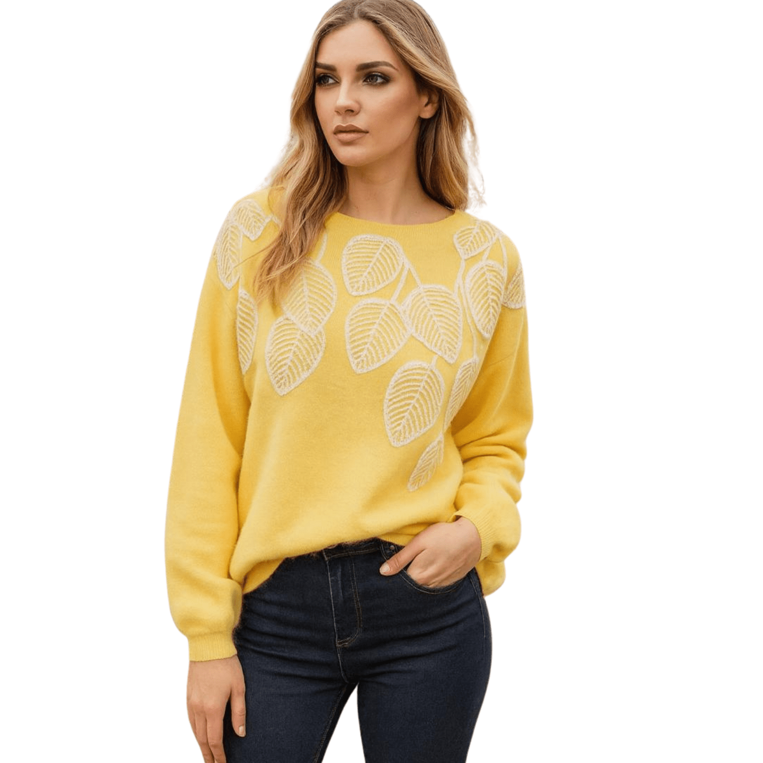 Woman wearing a yellow knit sweater with embroidered leaf design on the front, paired with dark jeans